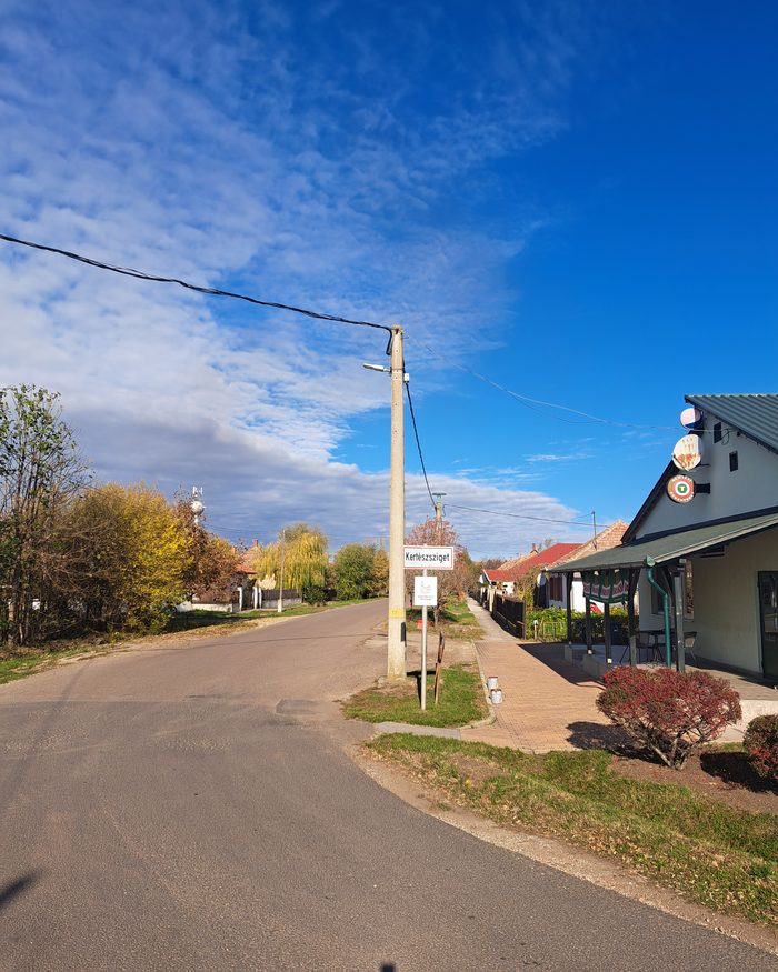 The main street of Kertészsziget with the new public lighting pole